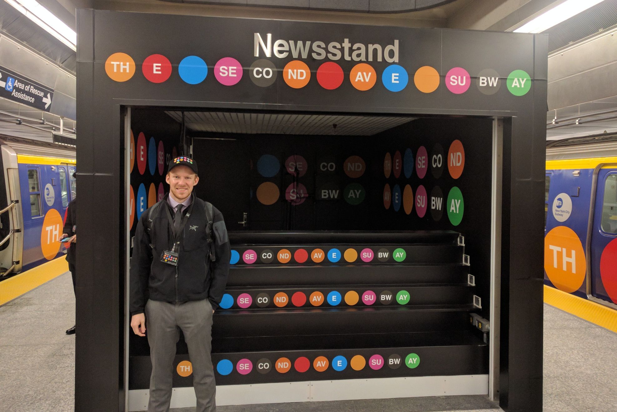 Erik standing in front of a decorated newstand at the open house for the Second Avenue Subway